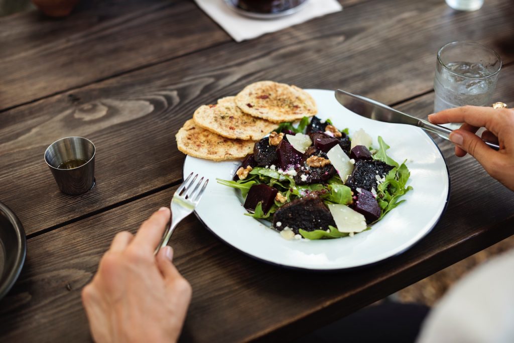 A lunch salad with nuts on top